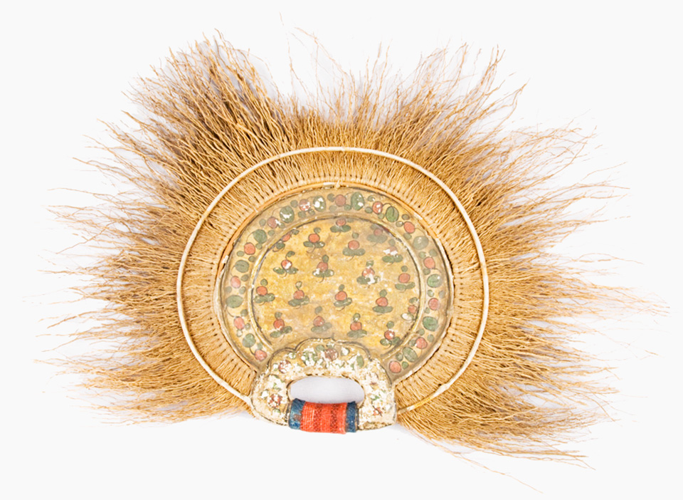 A mud-handled grass and painted paper fan from Sierra Leone in West Africa. A mud-handled grass and painted paper fan from Sierra Leone in West Africa.