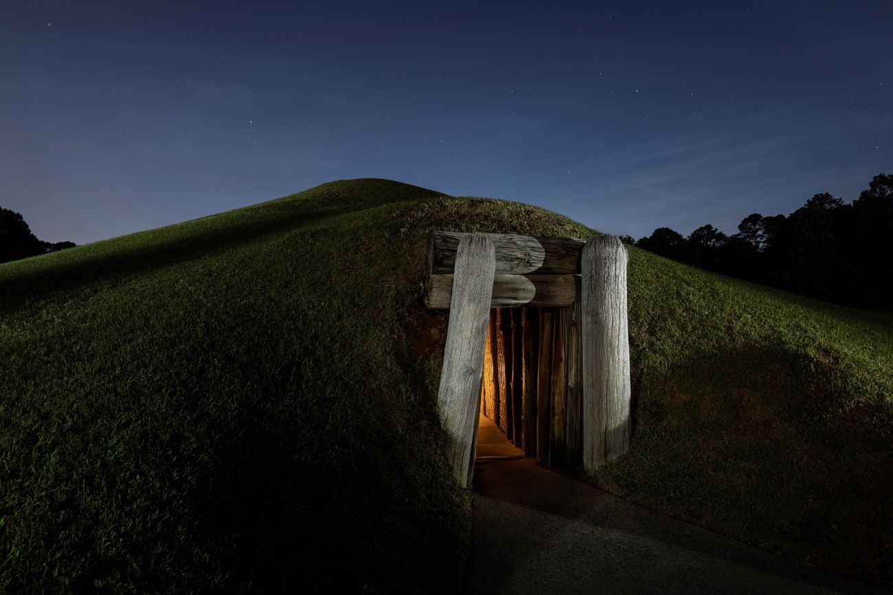 A view of the Earth Lodge entrance at night