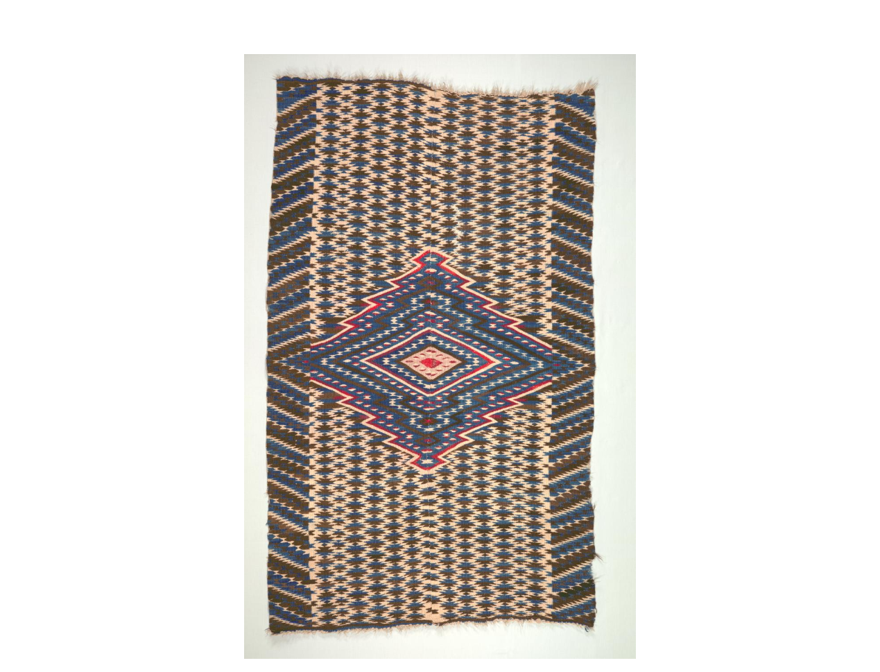 Saltillo Style Blanket Cleveland Art Example of Saltillo Style Blanket with an intricate blue and red diamond pattern.