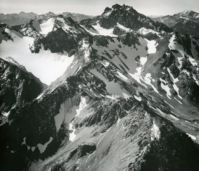 Three mountain glaciers along a rocky series of peaks and ridges.