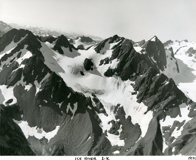 An aerial photo of a mountain glacier, taken at close range.