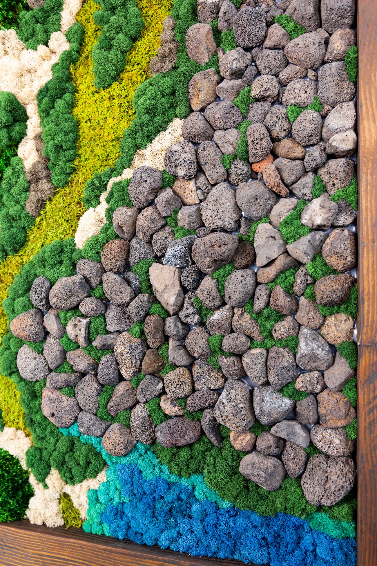 A close view of the rocks and moss of an art moss wall.