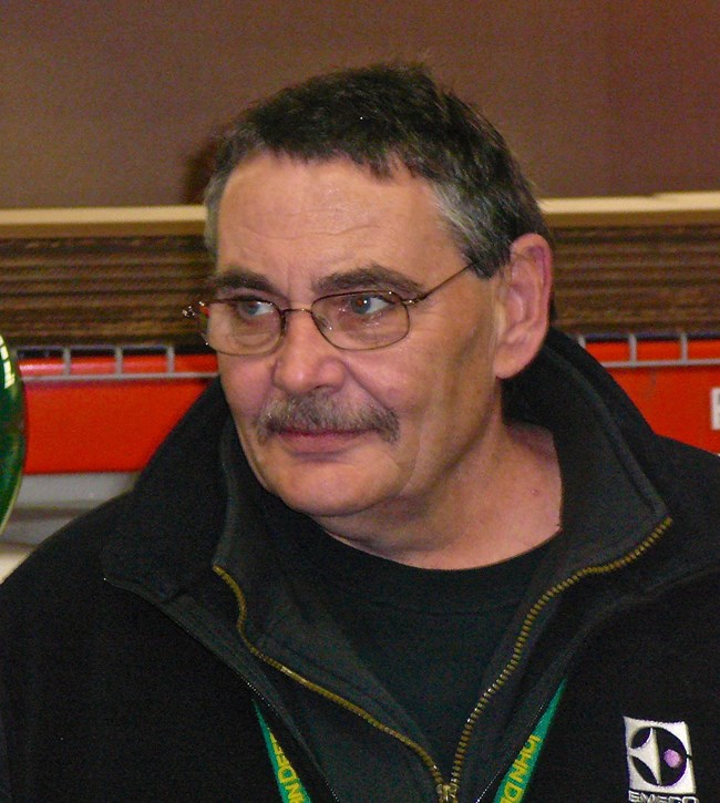 A man wearing glasses and a black shirt and pullover