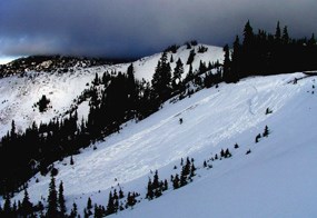 A snowy mountainside after an avalanche.