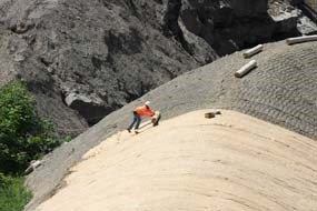 A straw blanket is laid out over the left abudment at the sie of the Elwha Dam.