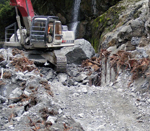 red excavator in narrow rock channel