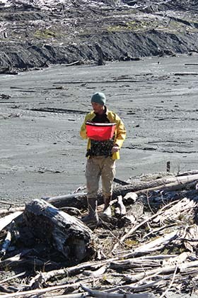 Park Volunteer Aaron Velasquez seeds in former Lake Mills.
