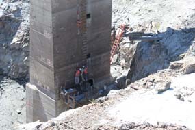 Worker prepare the intake tower at Glines Canyon Dam for removal.