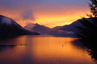 This photo depicts the colors of the sunset enclosed between to mountains and reflecting on Lake Crescent in the foreground.