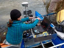 A member of the sediment team prepares equipment attached to one of the rafts.