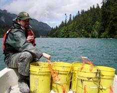 Park employee with buckets of silt collected behind the dams Park employee with buckets of silt collected behind the dams