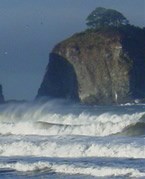 ocean breakers with rocky offshore island in background