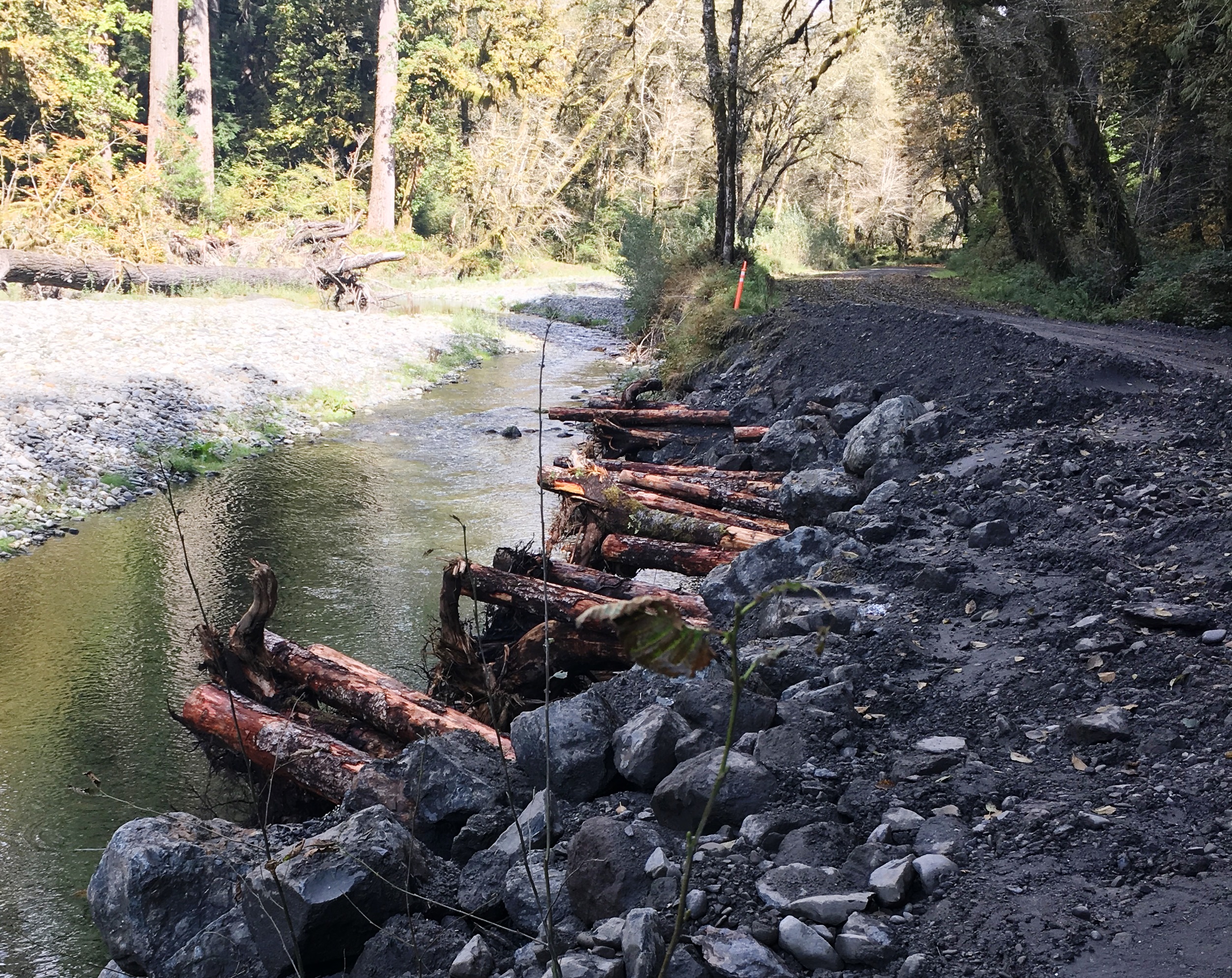 Road repair on a gravel road next to a river.