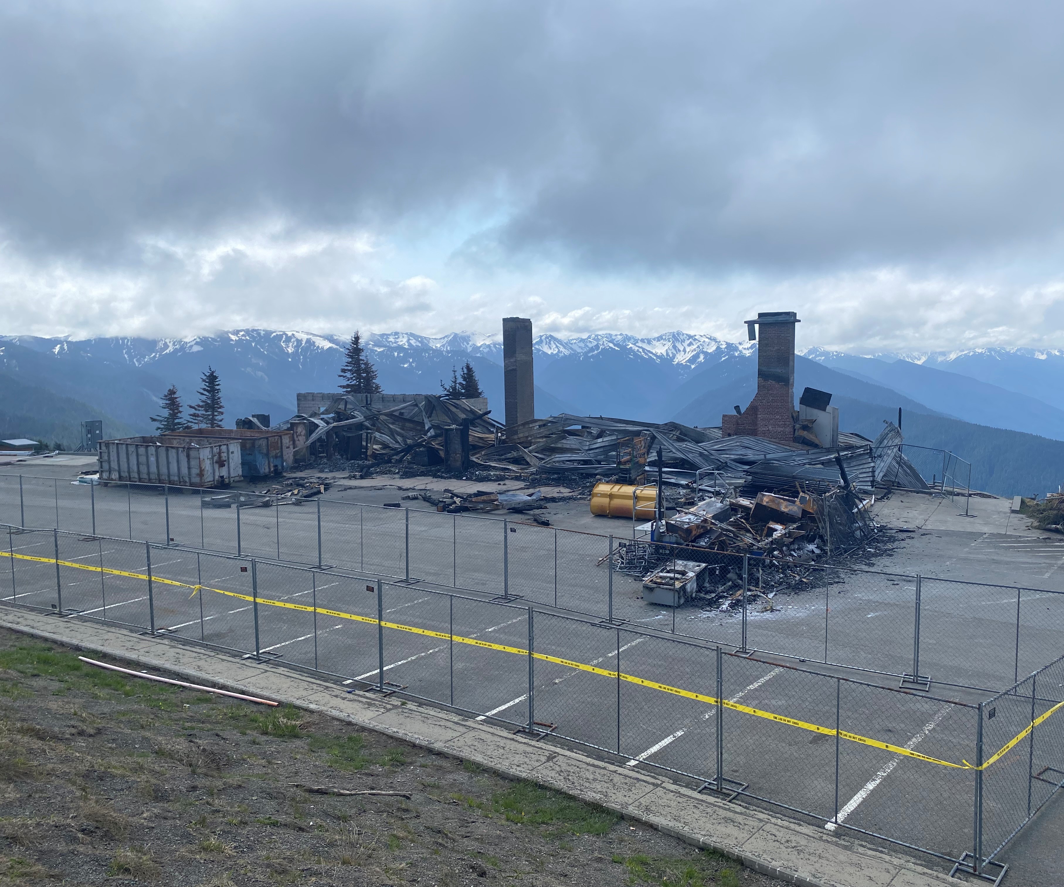 Burned building and debris in a parking lot area