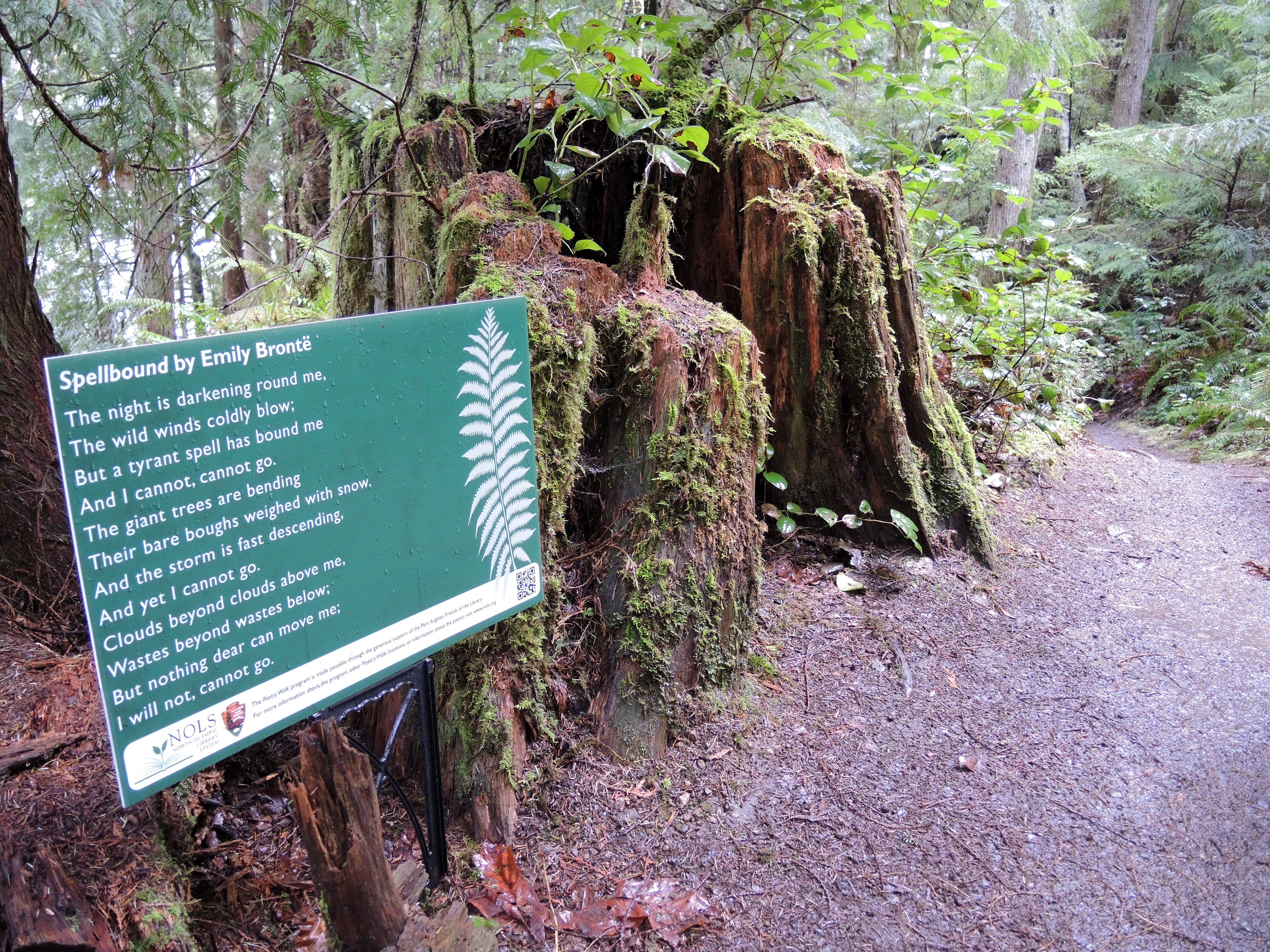 Sign with poetry along a trail.