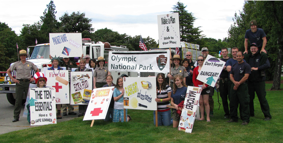 about 20 people, holding variety of signs