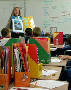ranger holding poster in classroom