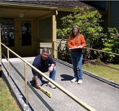 man and woman on entry ramp to building