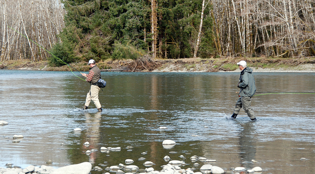 two men fishing in river