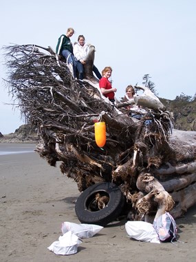 people on log with trash