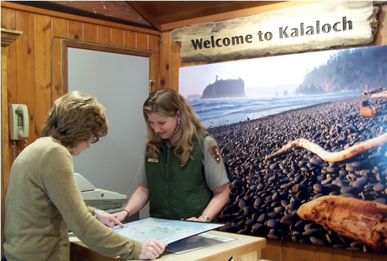 female ranger showing a map to visitor female ranger showing a map to visitor