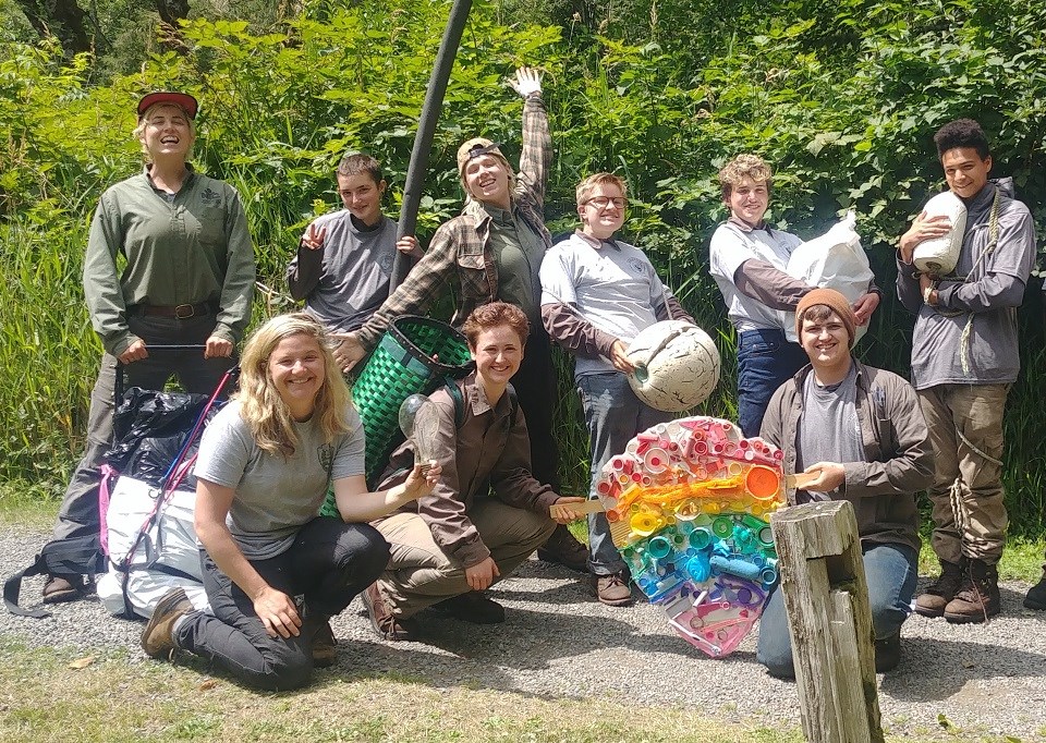 A group of volunteers poses outdoors.