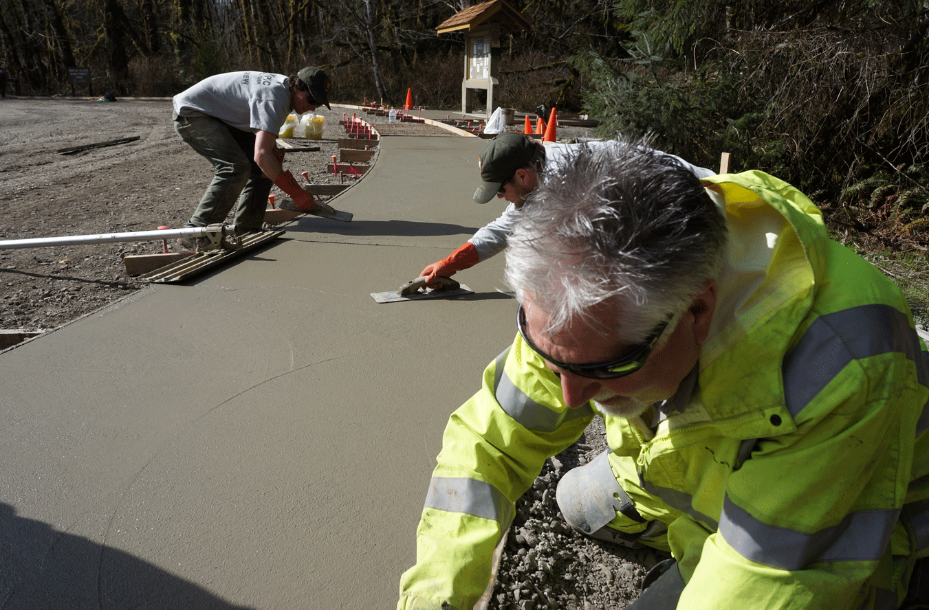 park staff finishing new concrete path