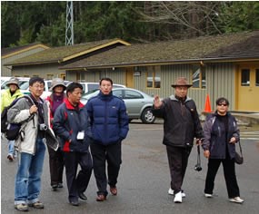 group of people walking through parking lot