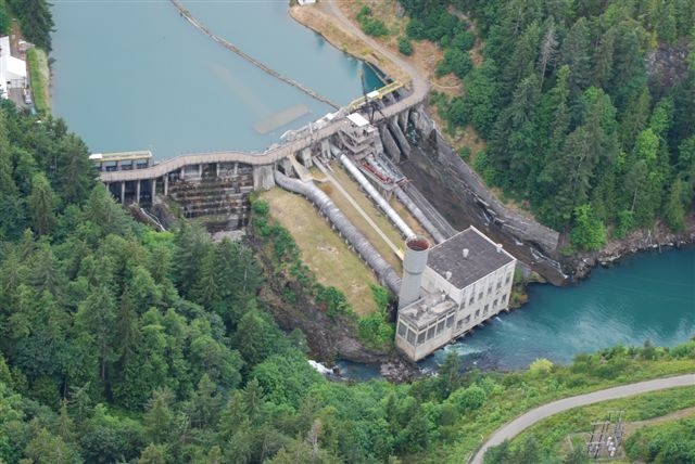 Aeriel view of Elwha Dam shows powerhouse, surge tower, dam face, lower pools and lake aldwell.