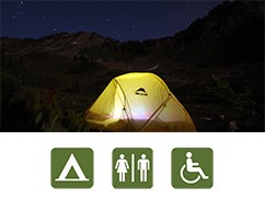 The glow of a tent beneath a starry sky at Deer Park.