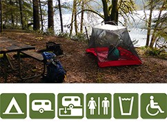 Tent in a campground by a lake.