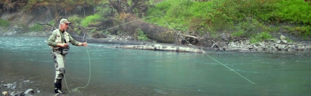 A man fishes in a river.