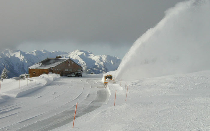 Snowblower at Hurricane Ridge in winter. Snowblower clears parking lot at Hurricane Ridge.