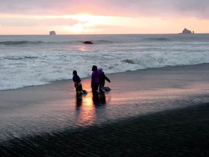Three kids playing in surf