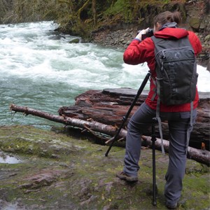 Photographer using a tripod to capture a photo.