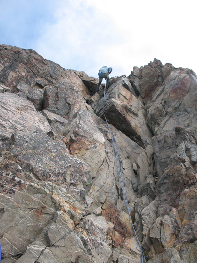 A climber rappelling down from the west peak of Mount Olympus.