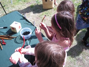 Children create their rock cycle bracelets during Rogue Valley Earth Day.