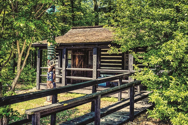 Log cabin surrounded by leafy trees