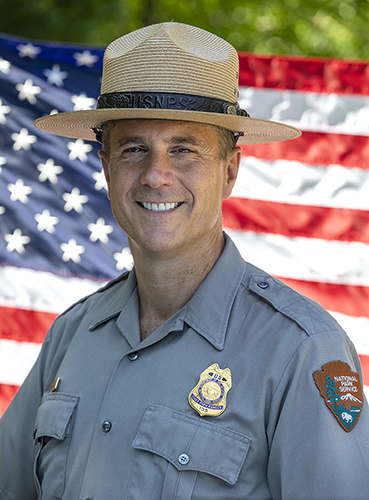 2Smaller_20180803_West Stuart West in NPS uniform and American Flag in backdrop