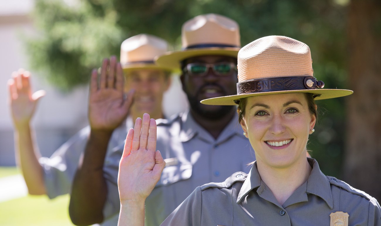 Three employees taking the Yellowstone Pledge