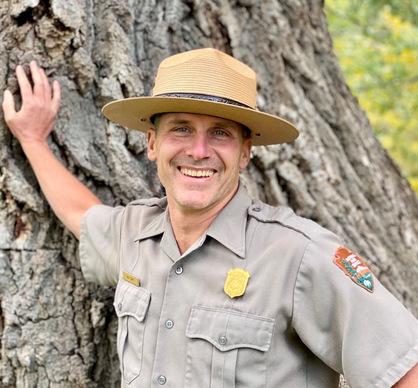 blobid2_1605210220944 Roy Zipp in NPS uniform standing in front of a tree