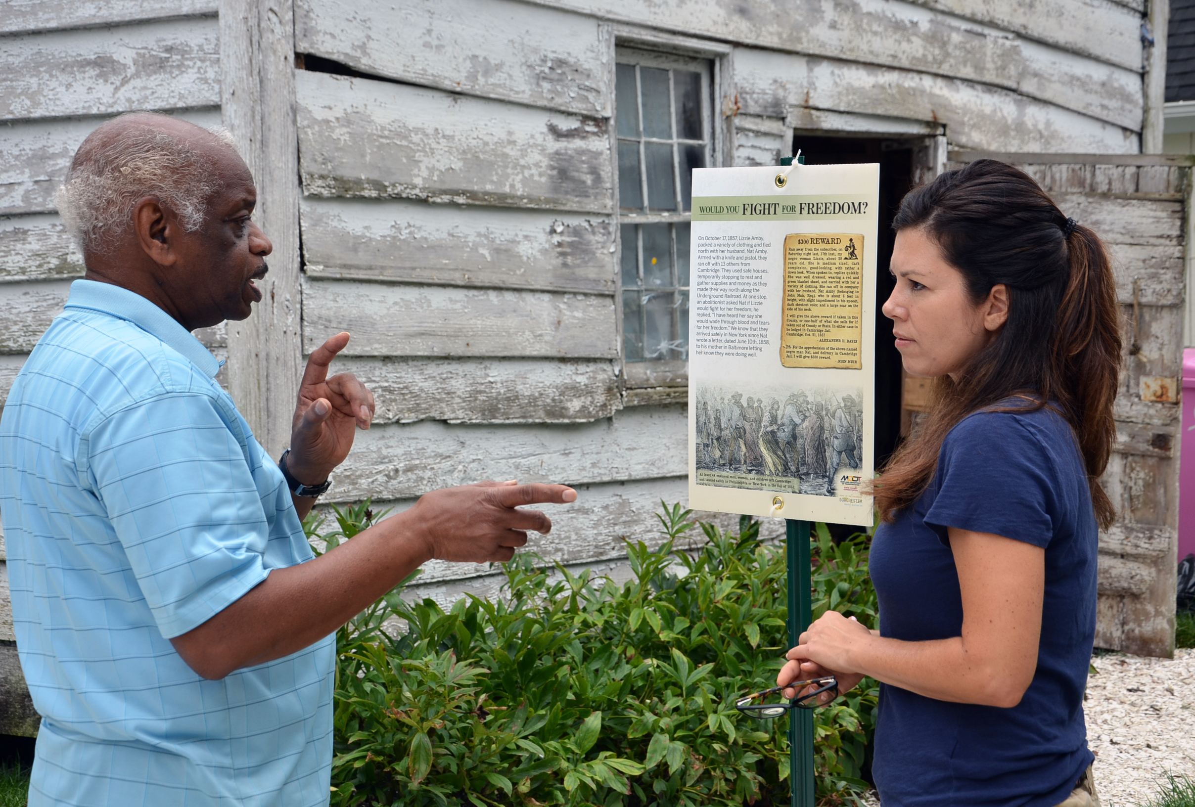 Lizzie Ambie Escape Site_Dorchester County Tourism Two people standing in front of a run down building discussing its history.