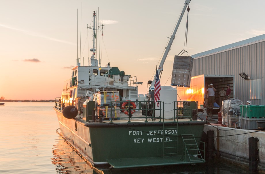 docked boat with supplies being loaded