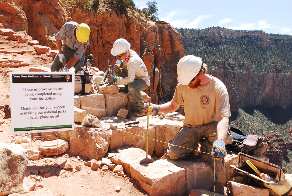 GRCA Trail Work Three employees or volunteers working on a section of trail in the Grand Canyon