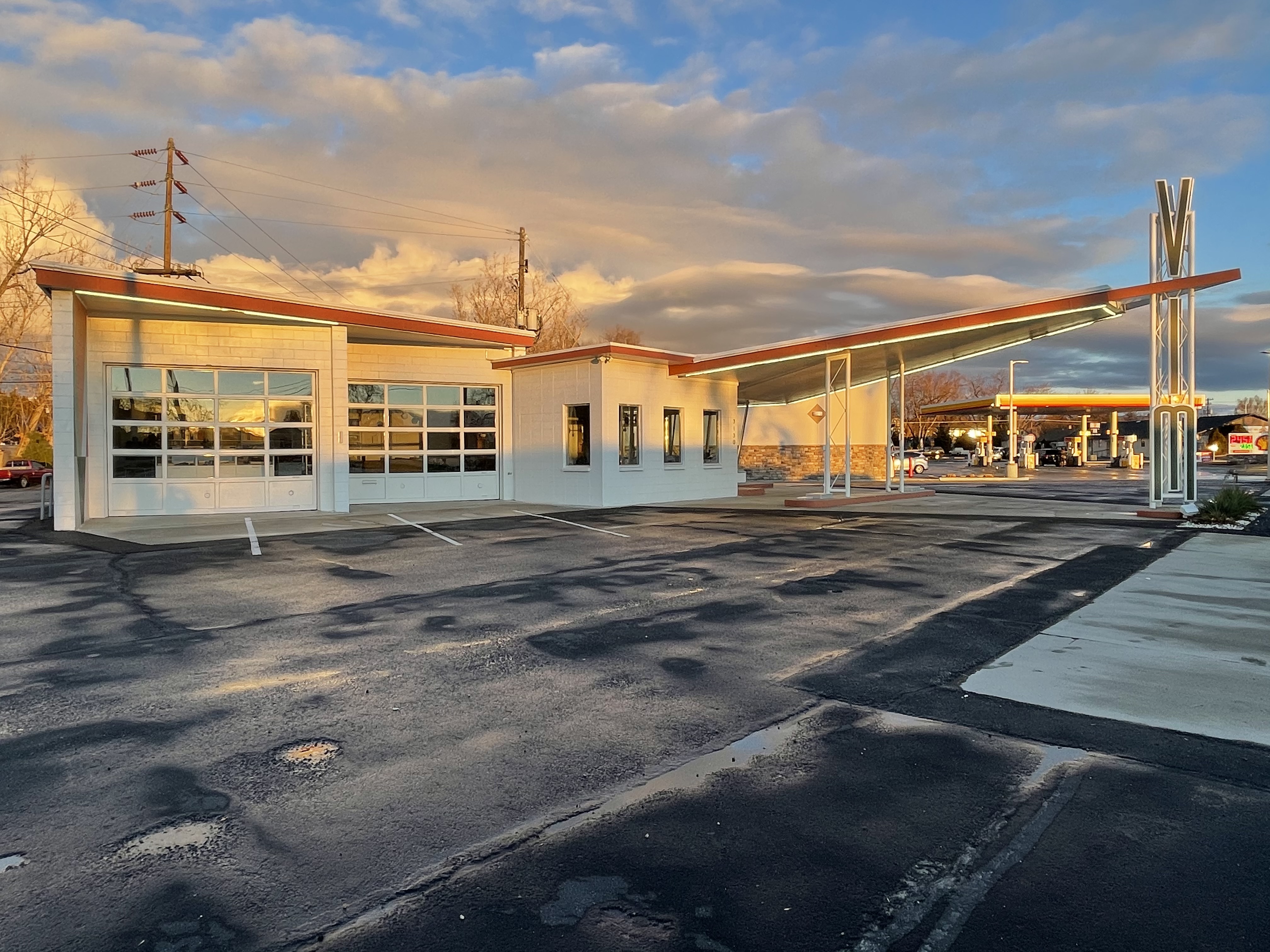 One-story mid-century modern style building with dramatic V-shaped canopies.