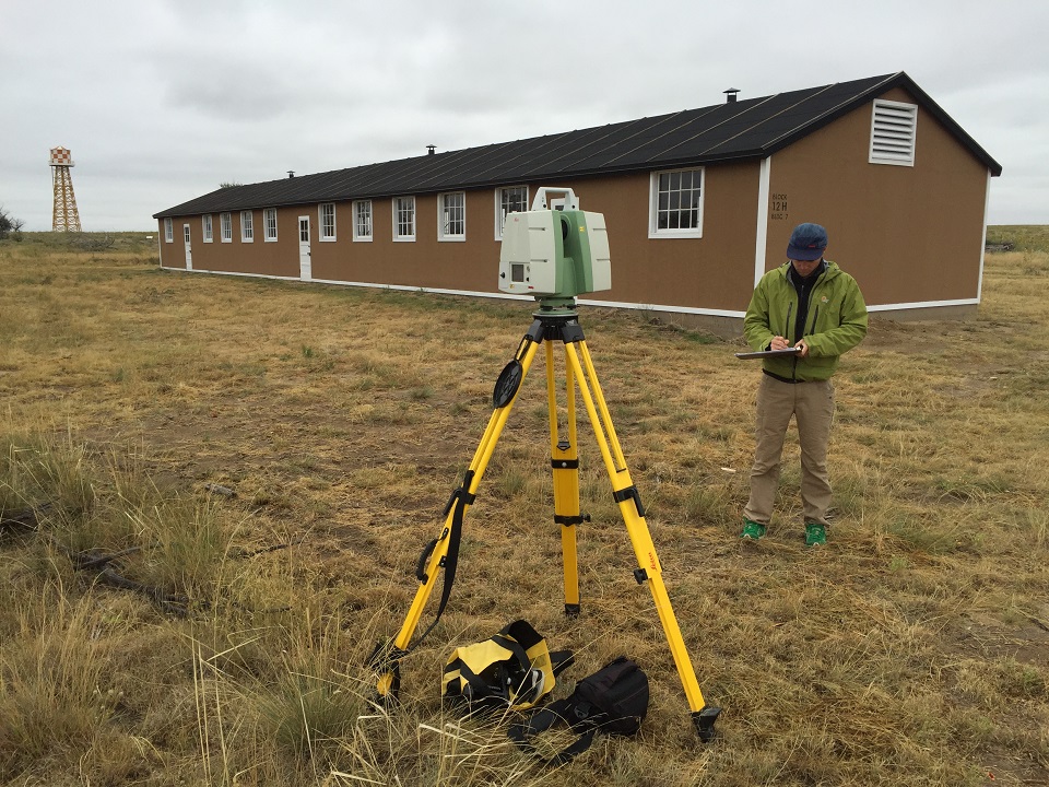 Man using Light Detection and Ranging (LiDAR) scanning technology to document existing and reconstructed buildings at the Amache incarceration site in Prowers County, Colorado.