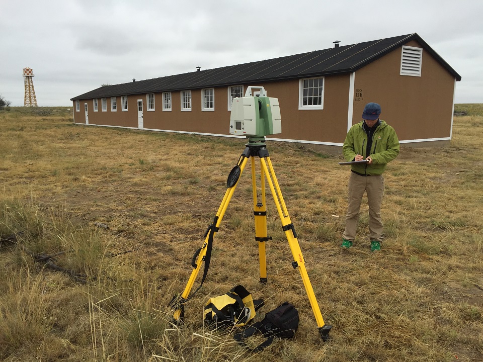 AmacheImage_CourtesyUCDandMikeNulty Man using Light Detection and Ranging (LiDAR) scanning technology to document existing and reconstructed buildings at the Amache incarceration site in Prowers County, Colorado.