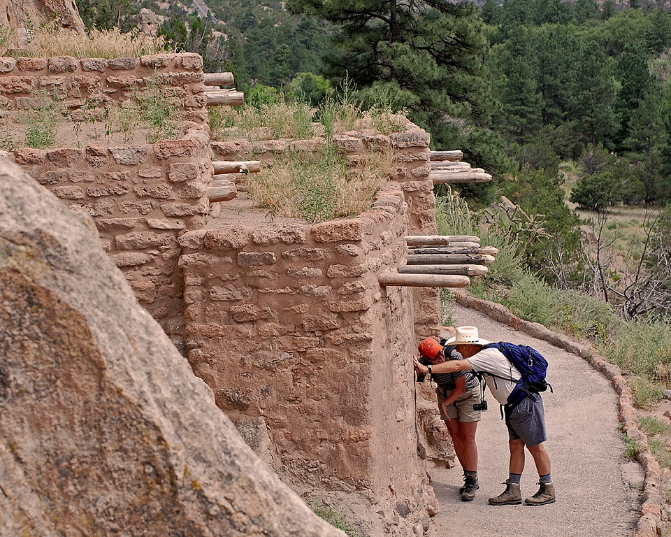 BAND Talus House Two visitors peering inside a Pueblo structure