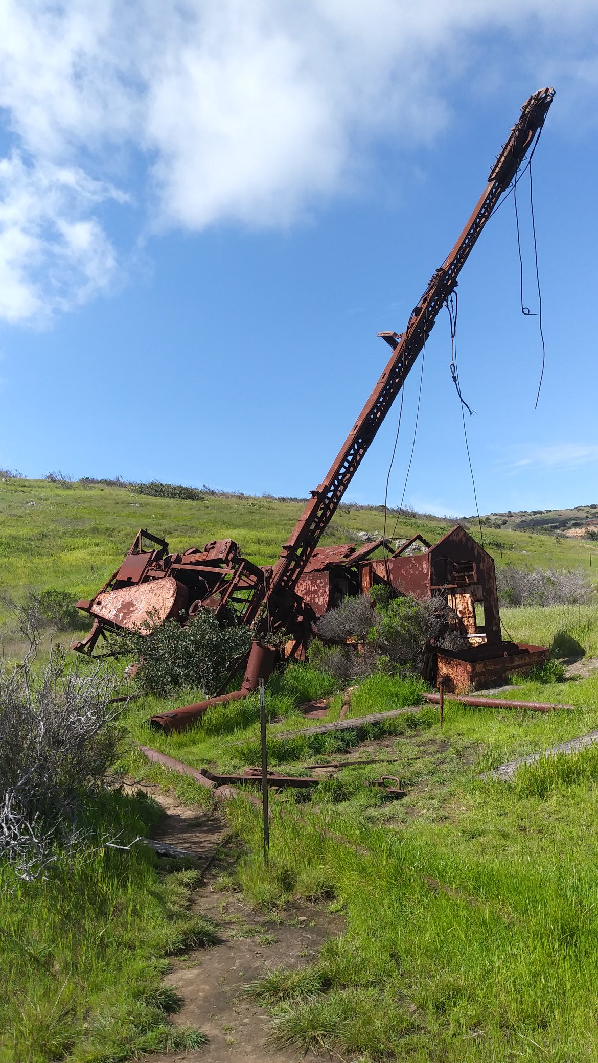 Abandoned oil rig on the side of a hill.