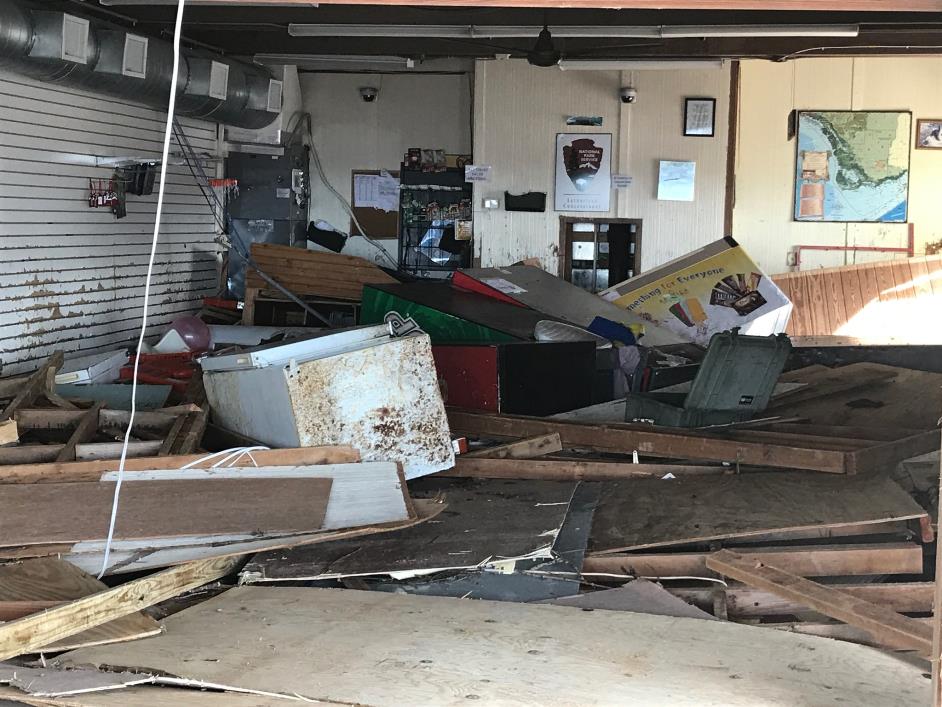 Gulf Coast Visitor Center at Everglades National Park after Hurricane Irma building and furniture debris in a room with an entire wall missing